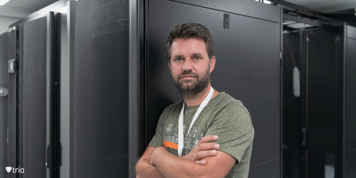 IT specialist posing in front of server room