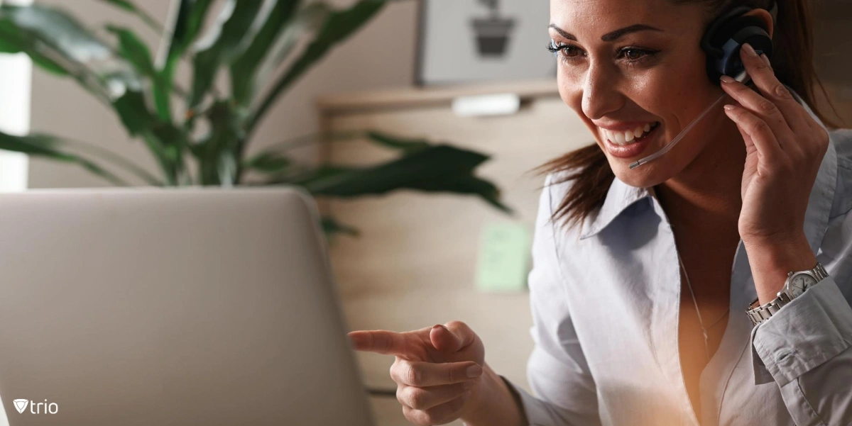 An employee using a laptop equipped with softphone applications to video call with her colleagues