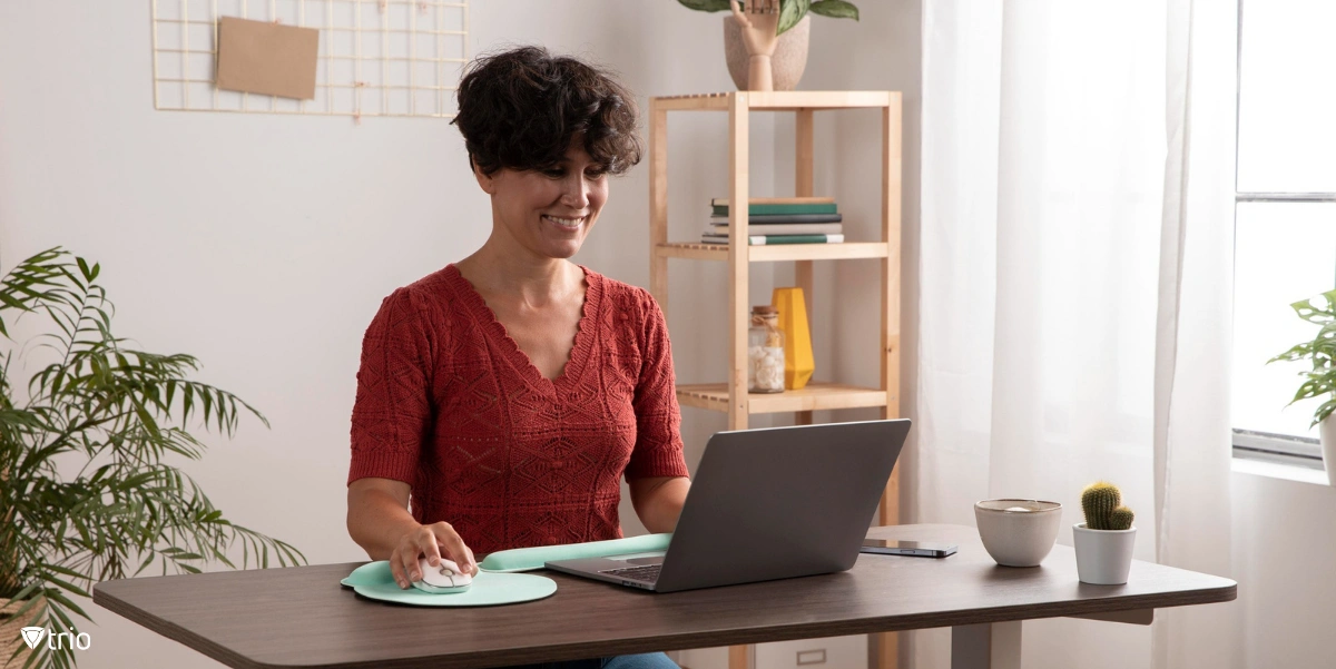 Woman working behind desk at home using her own device