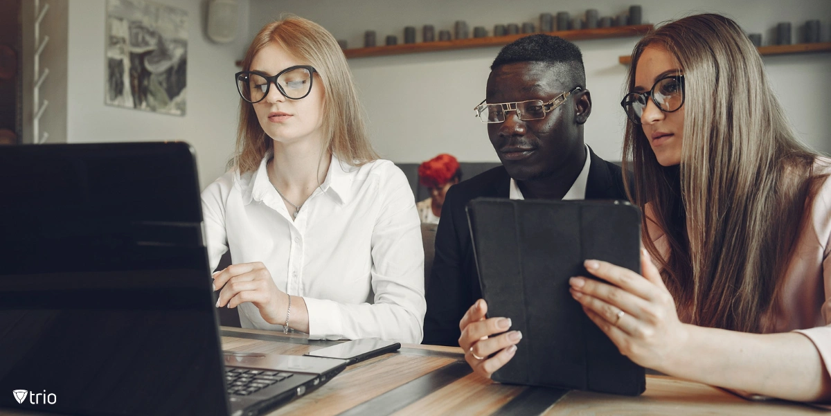 Three employees provisioning devices next to each other