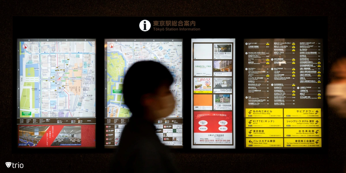Chinese passengers walking past digital signage