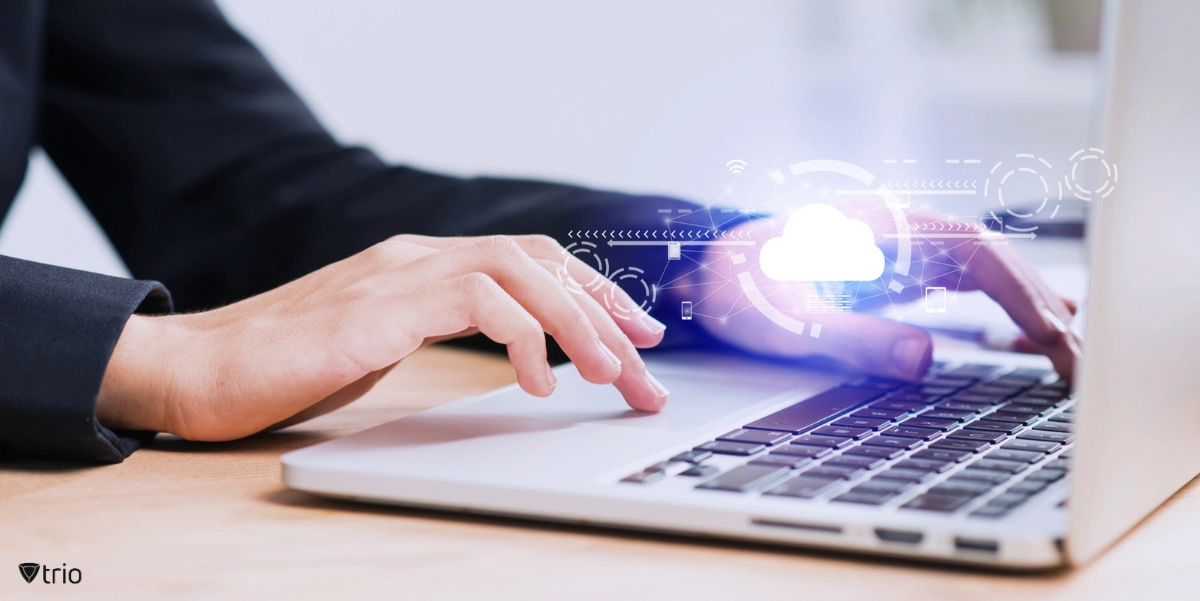 Someone working with a laptop, with a cloud icon shown above the keyboard.