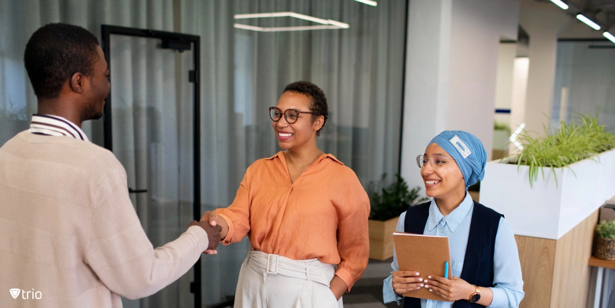 Manager offboarding an employee while another holds the offboarding checklist