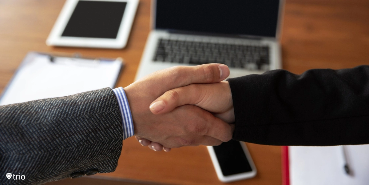 businesspeople shaking hands over company equipment agreement