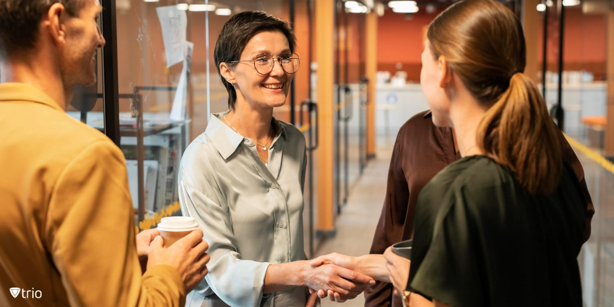 employee getting onboarded in the office and coworkers shaking hands