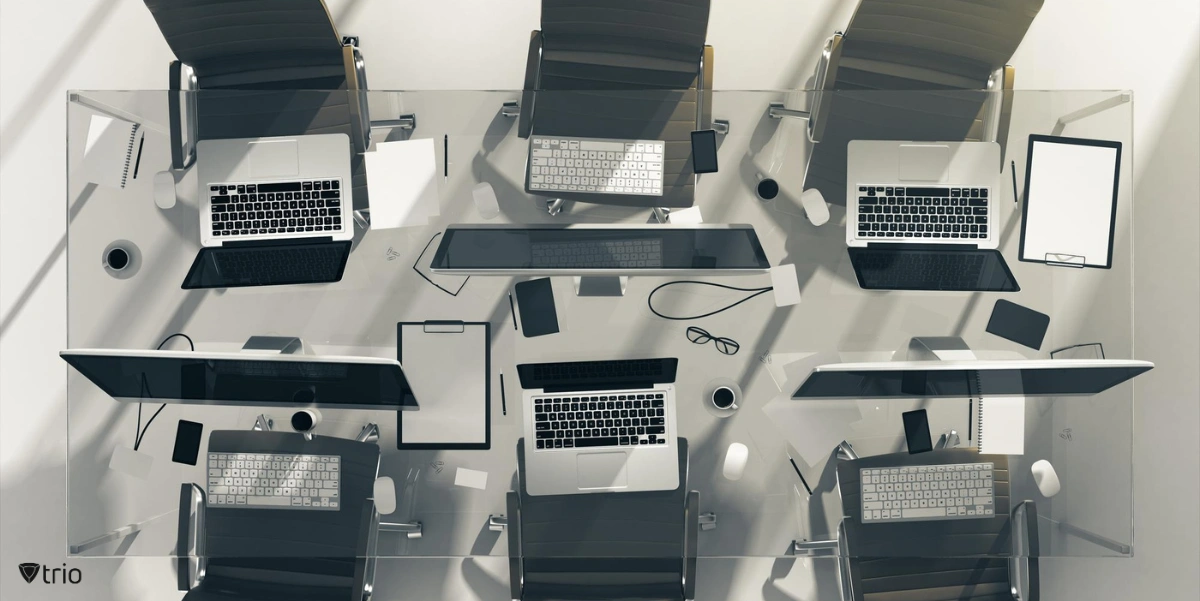 A top view of a desk with devices on it including laptops and computer PCs