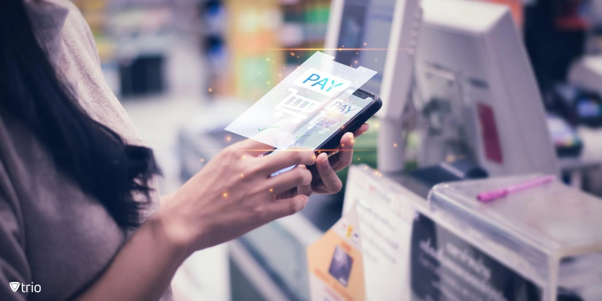 Woman holding smart phone at store paying