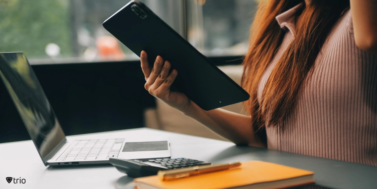 Woman using mobile devices secured with MDM in an office