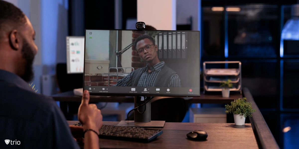 Man working remotely and using laptop at table