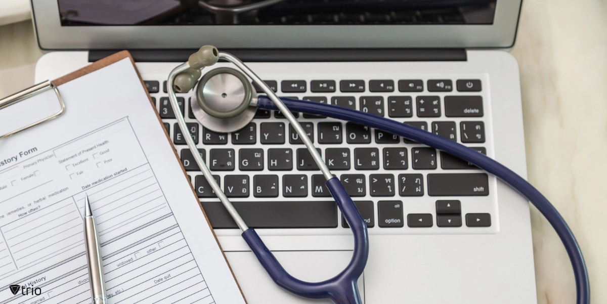 stethoscope on a laptop and a health information form