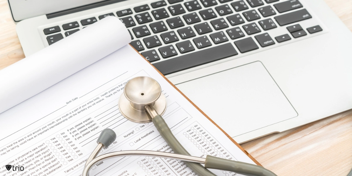 stethoscope on a laptop and a health information form