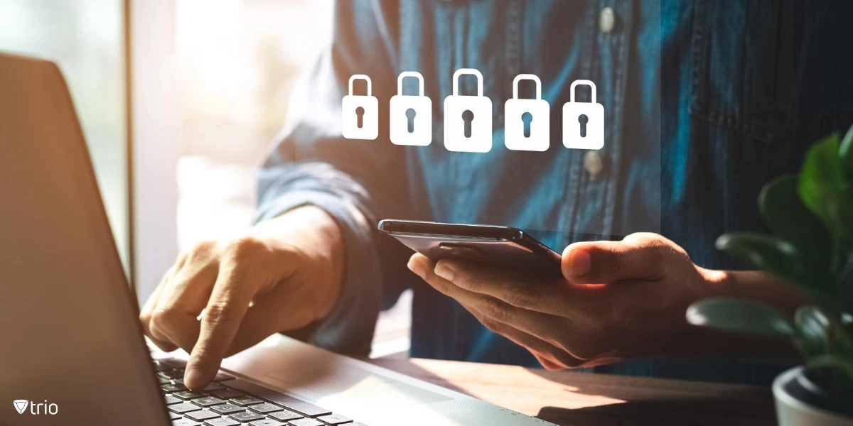 Someone using their smartphone to access something on their laptop, showing how multi-factor authentication works