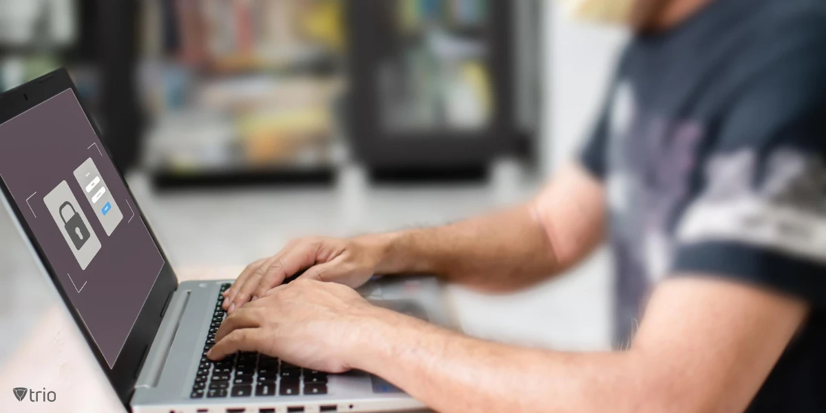 man using a laptop with a login window and a lock on the screen