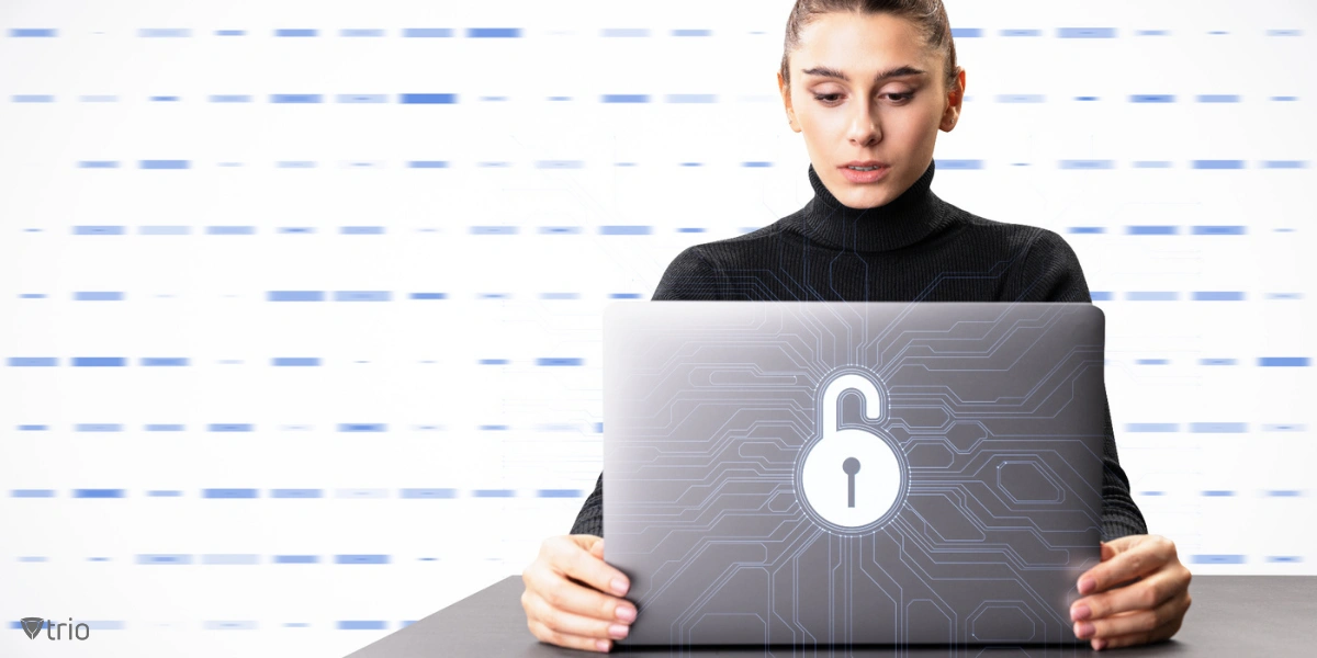 woman using a laptop with a lock icon on the back of it