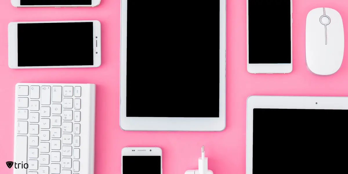 A collection of digital and mobile devices on a pink background.