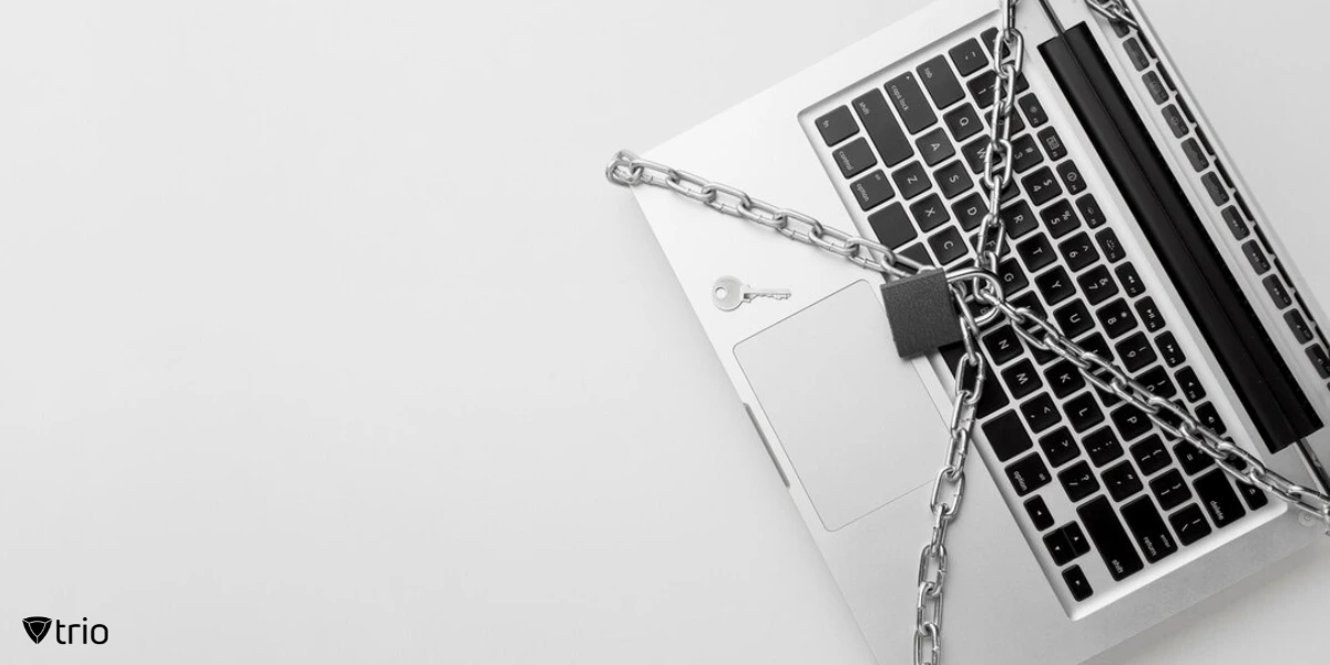 Top view of a laptop protected by a metal chain and a lock.