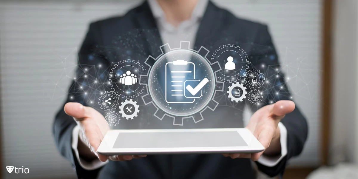 A professional in a suit presents a tablet with a futuristic digital overlay of gears, checklists, and user icons, representing automation, quality control, or compliance management in a business setting.