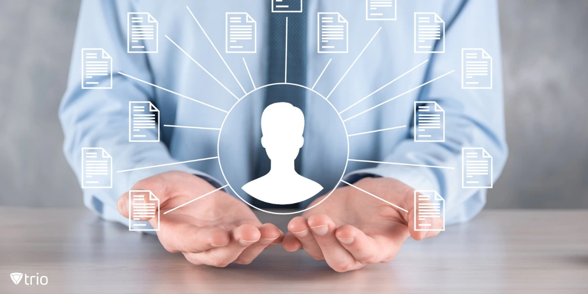 A businessman in a blue shirt holds out his hands, with a digital illustration of a user icon surrounded by document icons, symbolizing data or identity management.