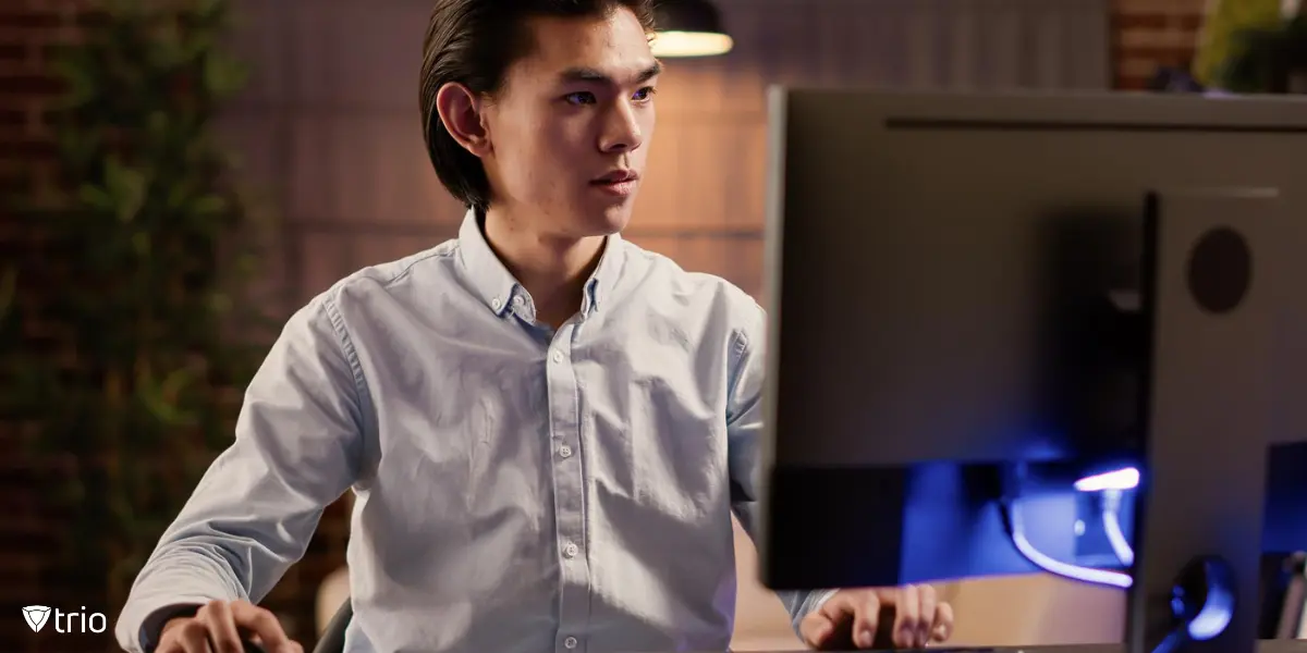 An IT admin managing BitLocker with MDM behind a computer.