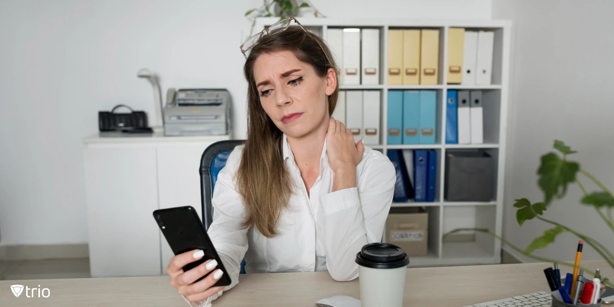 An employee distracted by her smartphone at the office.